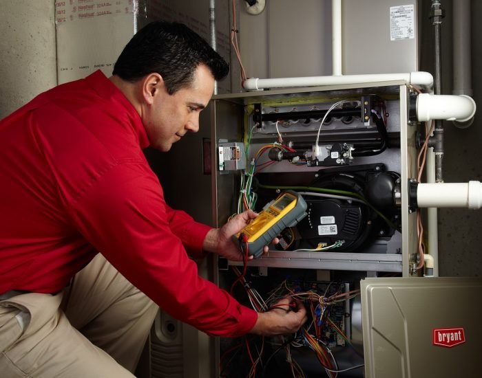 Technician tuning up furnace